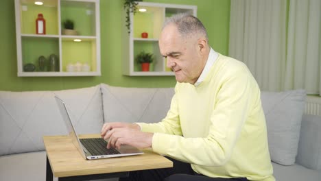 Middle-aged-man-working-on-laptop-at-home.